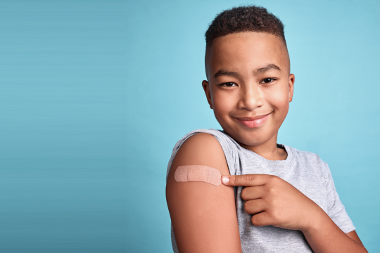 smiling boy with bandaid Annapolis Pediatrics flu clinic dates