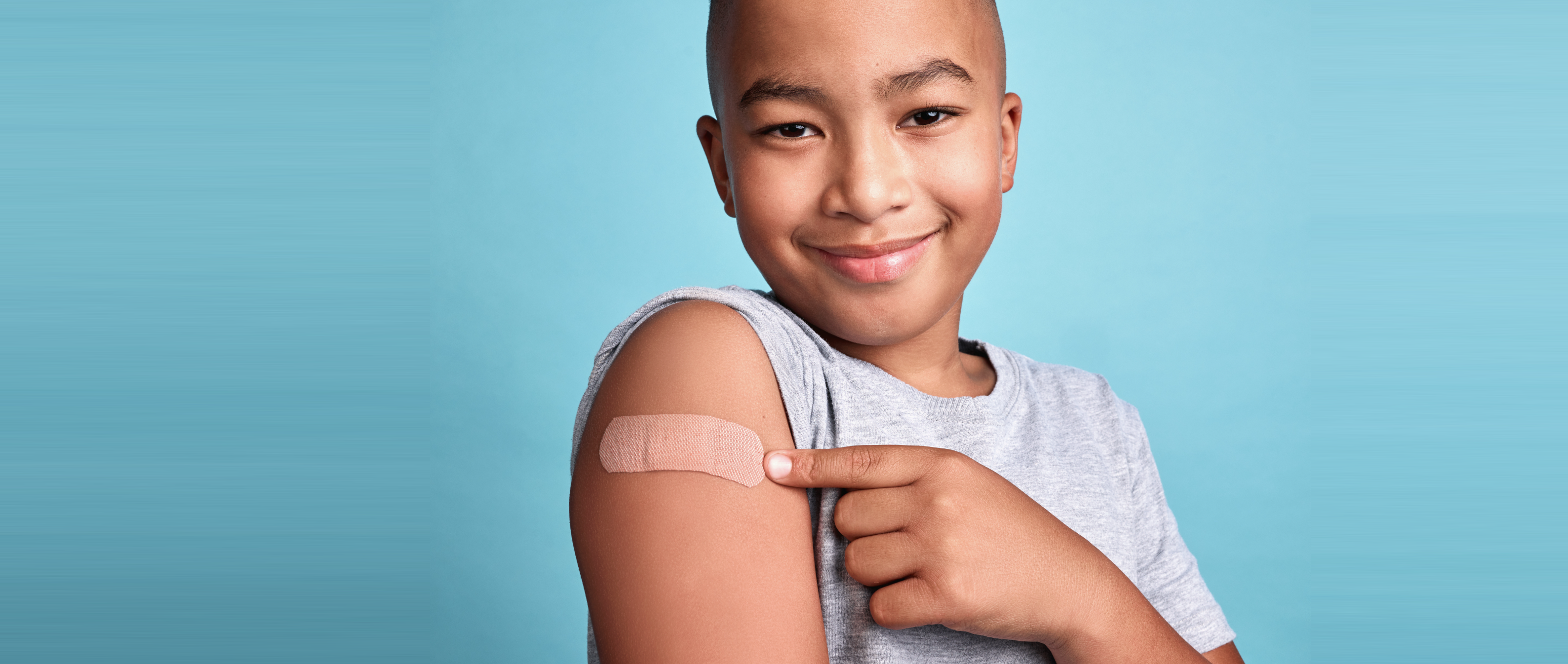 smiling boy with bandaid on arm flu vaccine options at Annapolis Pediatrics 2026