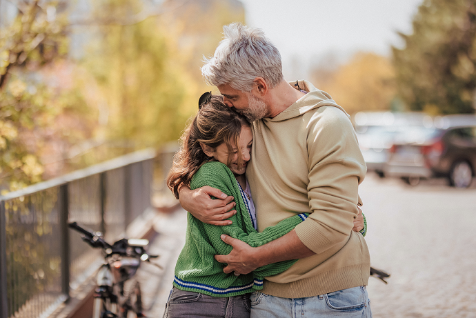 dad hugging teen daughter perfectionism live class