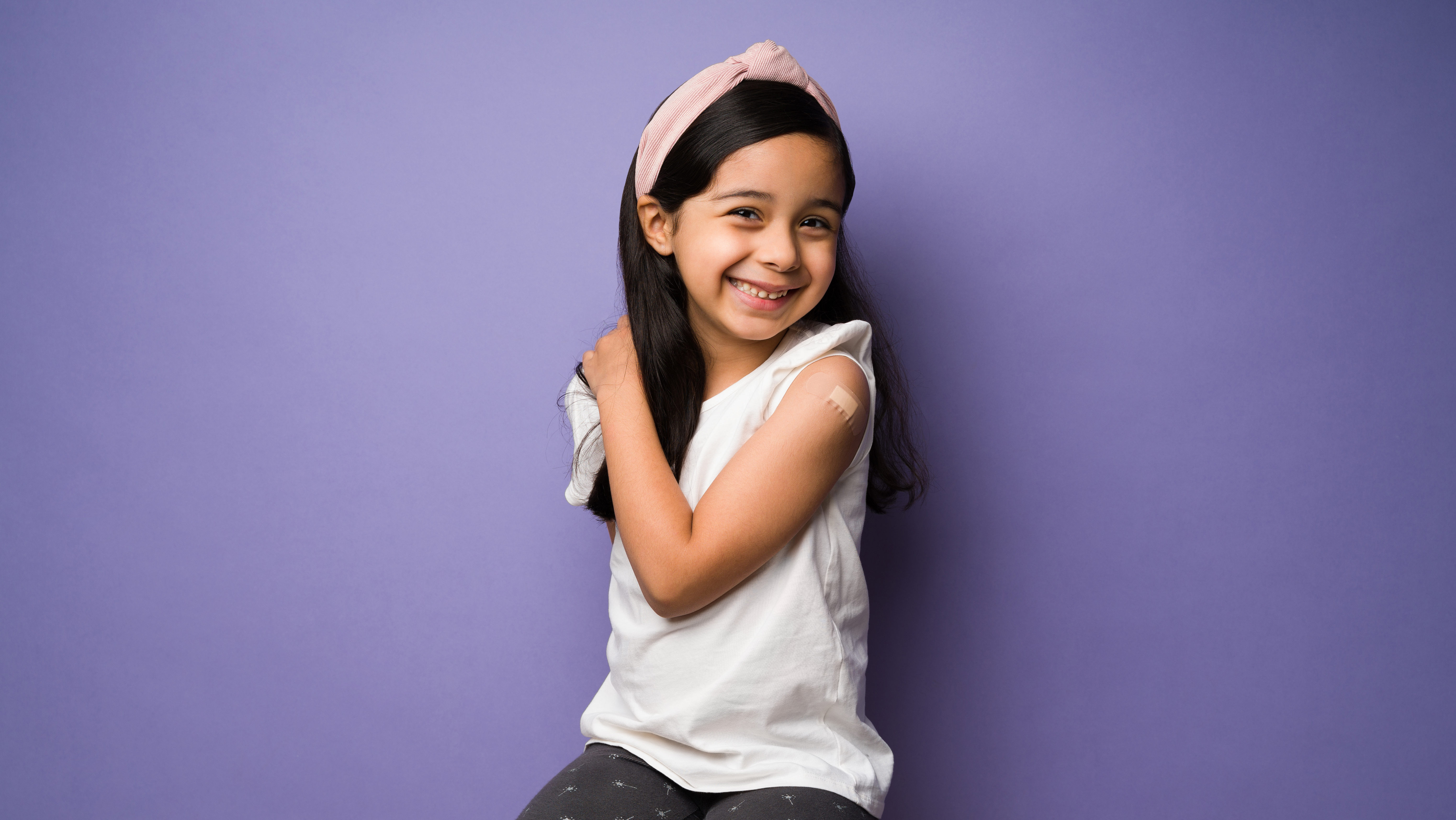 girl with bandaid after flu shot vaccine flu shot clinic annapolis pediatrics smiling kid influenza