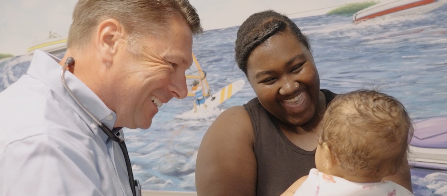 Dr Rice with baby getting checkup in office pediatrician visit well baby Pasadena office Annapolis Pediatrics