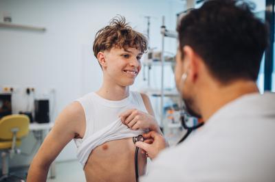 teenage male getting a pediatrician checkup in office visit well visit