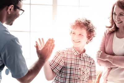 boy high fiving parents