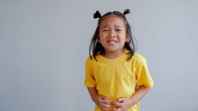 girl clutching stomach in pain tummy ache IBD IBS digestion