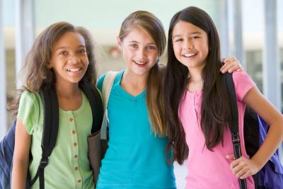 puberty in girls 3 elementary school girls in group african american white hispanic